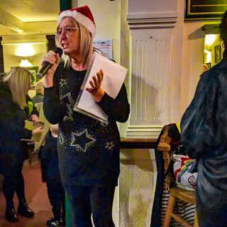 Kathy hosting a charity quiz at the Green Dragon in Bungay