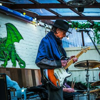 Laurie from East Coast Blues Band playing outside at the Green Dragon in Bungay